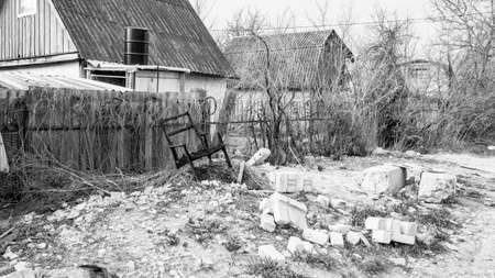 Burnt chair, similar to the throne, standing on a pile of construction debrisの写真素材