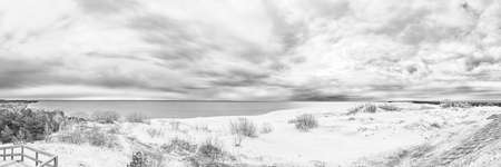 Sand dunes of the Curonian Spit in the cloudy weather with the sky covered with clouds on the shore of the Curonian Bayの写真素材