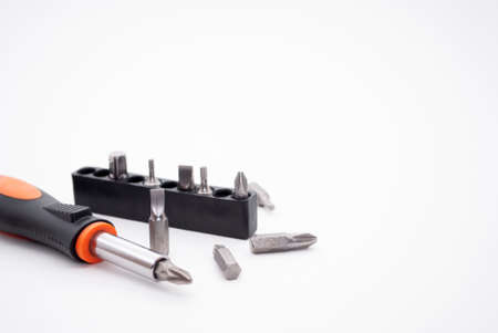 Screwdriver and screwdriver bits on a white background with copy spaceの写真素材