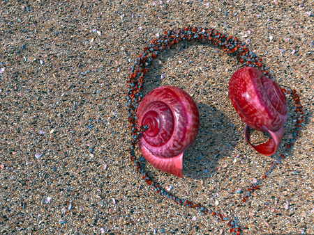 headphones from seashells on the sand as vacation tourism relaxing concept 