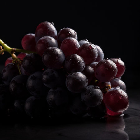 Bunch of black grapes with water droplets on black background. AI-generated imagesの素材