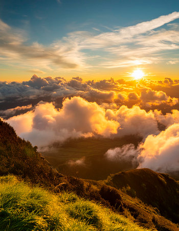 Sunrise on the top of the mountain with clouds in the skyの素材