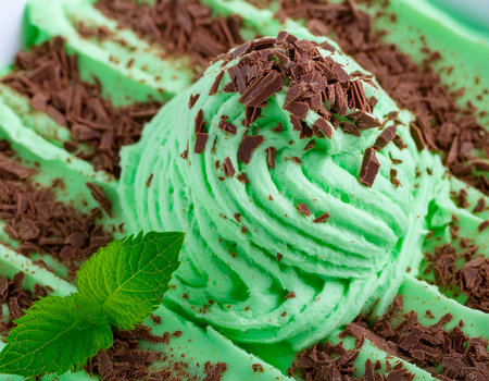 Green ice cream with chocolate and mint on white background. Selective focus.の素材