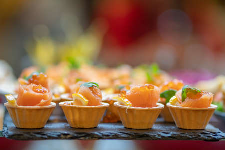 Tartlets with red fish and caviar. Close-up of gourmet food.の写真素材