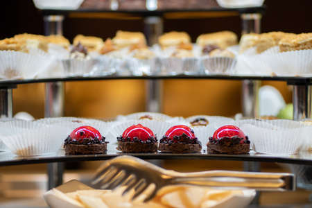 Mix of sweets, cakes, muffins. Beautifully laid out on a glass showcase. Setout.の写真素材
