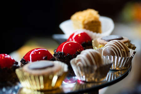 Mix of sweets, cakes, muffins. Beautifully laid out on a glass showcase. Setout.の写真素材