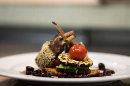 Beautifully decorated rack of lamb with vegetables and sauce.の写真素材