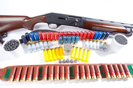 gun and hunting cartridges on a white background