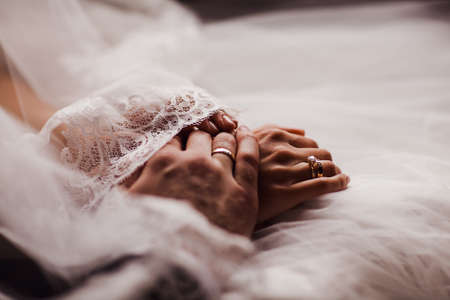 the bride and groom hold handsの写真素材