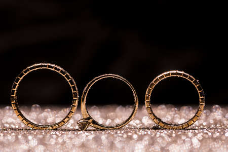 gold wedding rings on an abstract background with copy spaceの写真素材