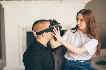 young couple spend time together playing VR in living roomの写真素材