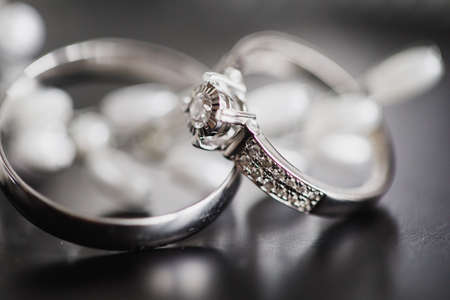 gold wedding rings on an abstract background with copy spaceの写真素材