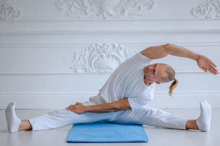 Man doing yoga at home. fitness, yoga and healthy lifestyle conceptの写真素材