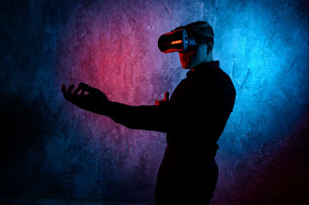 Young man playing a virtual reality video game. Vr game with shotgunの写真素材