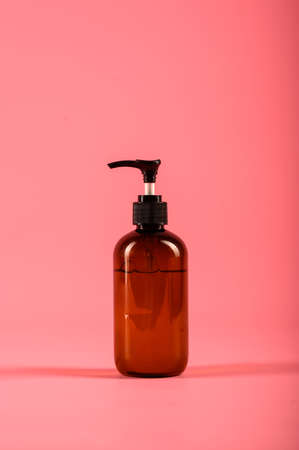 Plastic bottles with dispenser pumps isolated on pink background. Mock upの写真素材