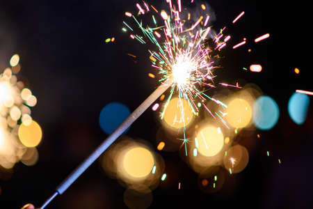 Burning sparkler, Happy New Year. Bengal fire sparkles against the background