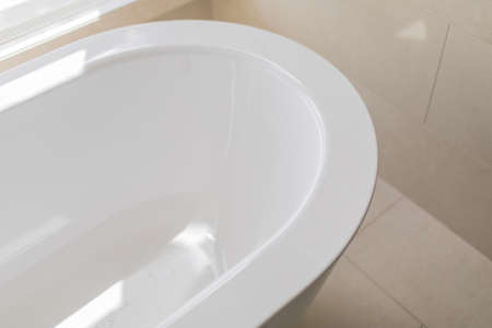 Pure white bathroom interior with separate bathtub. Bathroom with big windowsの写真素材