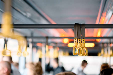 Hanging handhold for standing passengers in a modern train. Suburban and urban transport