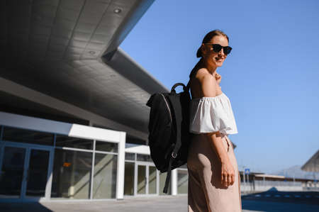 girl tourist with black backpack and sunglassesの写真素材
