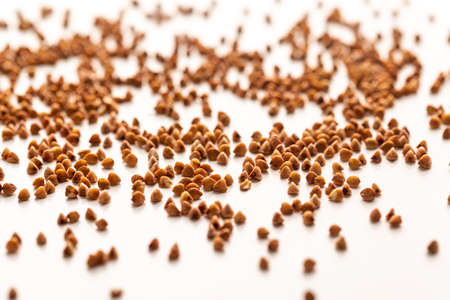 Close up of buckwheat grains isolated on white background. Top viewの写真素材