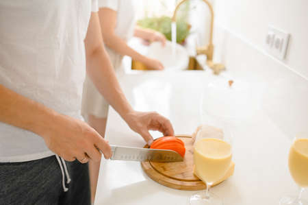 beautiful young couple cooking in kitchen at home