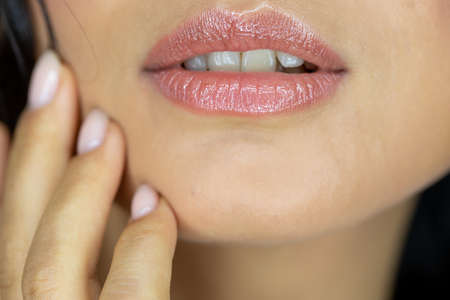 Close-up perfect natural lip makeup beautiful female mouth. Plump sexy full lips. Macro photo face detailの写真素材