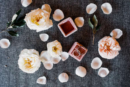 wedding rings in a box on a background of flowers. layout. top viewの写真素材
