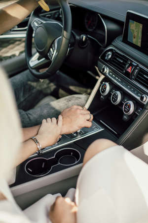 Hands of lovers together in a car close upの写真素材