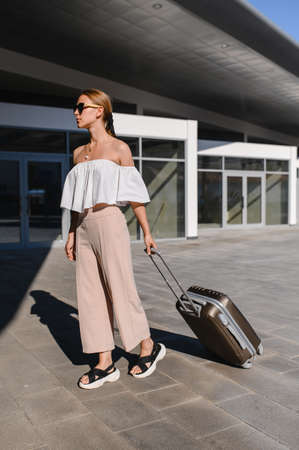 Woman traveler tourist walking with luggage at train station. Active and travel lifestyle conceptの写真素材