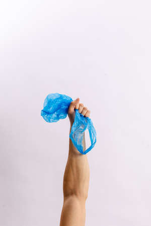 Hands hold trash on a light background. The concept of separate trash, stop plastic, recyclingの写真素材