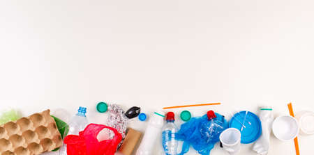 plastic trash on a white background. environmental pollution. Flay lay. Copy space top view.