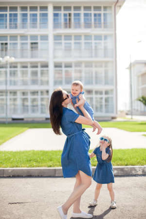 young mother and daughters outdoor. Happy family.の写真素材