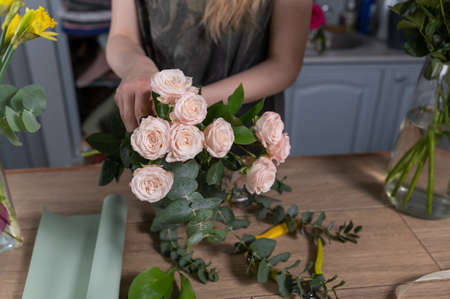 Florist girl makes a bouquet. Flower shop.の写真素材