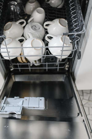 Open dishwasher with clean glass and dishes, selective focus.の写真素材