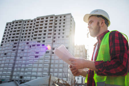 Construction concept of Engineer or Architect working at Construction Site with blue printの写真素材