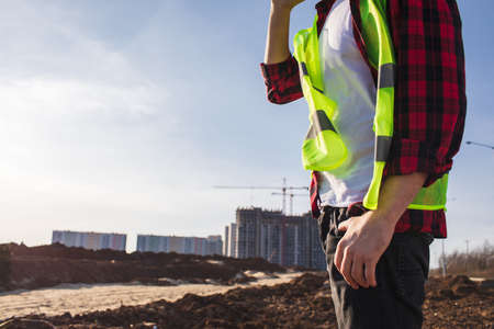 construction engineer talking on the phone, discussing project detailsの写真素材