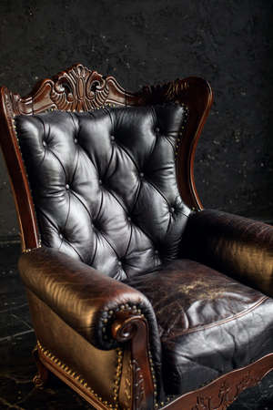 Black genuine leather classical style sofa in black room. Modern interior. Loftの写真素材