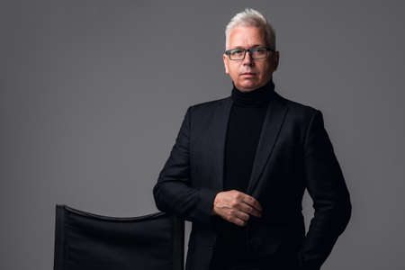 Confident businessman. Confident middle-aged man in formalwear and looking at camera while standing...