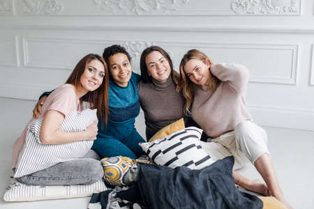 portrait of group girlfriends of different nationalities, female friendship. Funny girls have a party at homeの写真素材