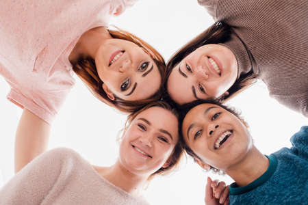 Image of a happy young women multiracial friends posing isolated over white wall background looking at camera.の写真素材