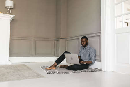 Happy positive black business man talk on video call with business partner, smiling african American man employee have online conversation on laptopの写真素材