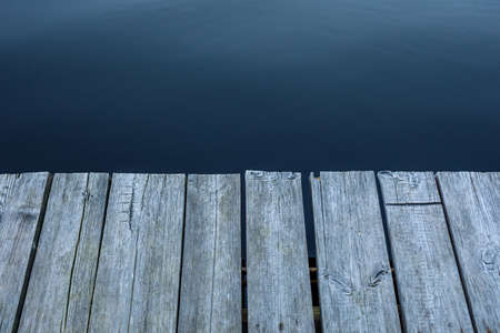 Wooden pier. table top on blue lake