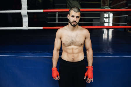 bare-chested boxer stands near the ring. boxingの写真素材