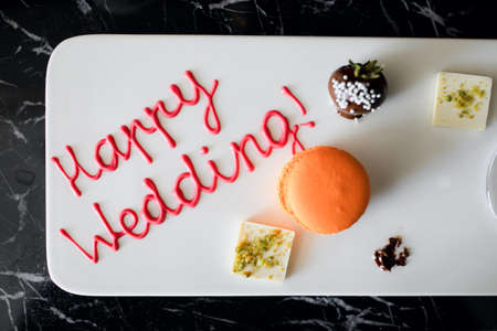 a compliment from the hotel for the bride and groom. Champagne and sweets with the inscription happy weddingの写真素材