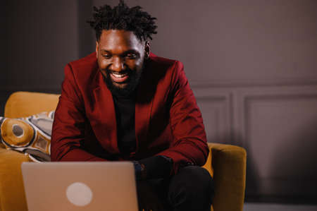 a black man works at a laptop close-up of his face. video conferences