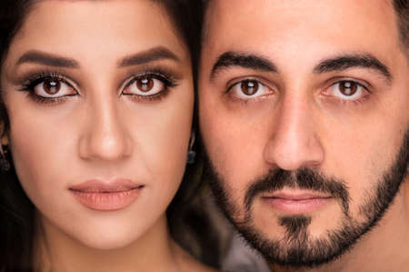 Muslim woman and man. Close up Portrait of a young arab girl and man in traditional dress.の写真素材