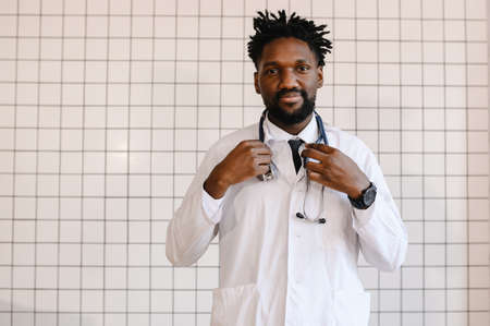 close-up portrait of black doctor smiling and looking at cameraの写真素材