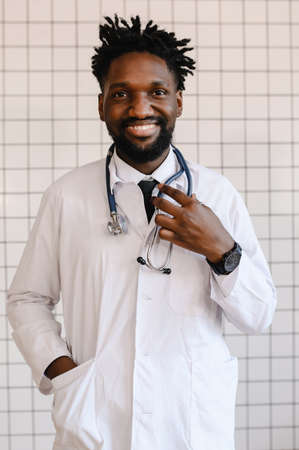close-up portrait of black doctor smiling and looking at cameraの写真素材