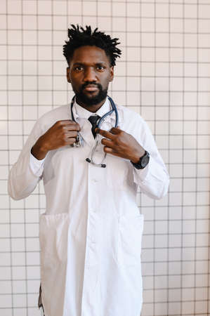 close-up portrait of black doctor smiling and looking at cameraの写真素材