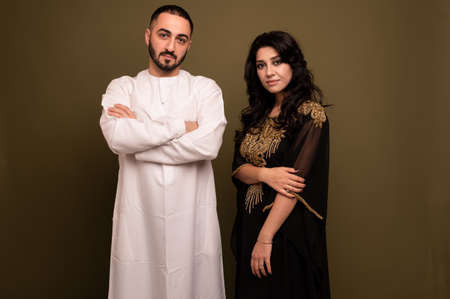 Muslim woman and man. Close up Portrait of a young arab girl and man in traditional dress.